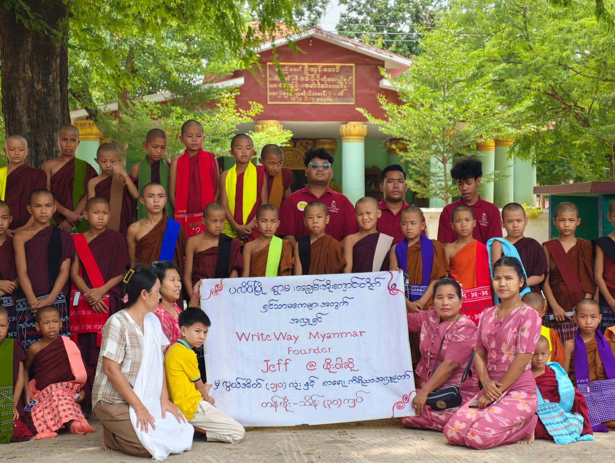 Students in Myanmar receiving school supplies